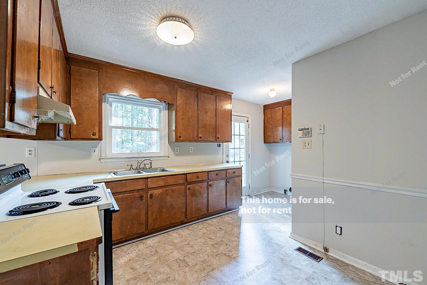 4903 Fayetteville Road Durham, NC 27713 - Photo 5 of 19 a kitchen with a sink cabinets and window