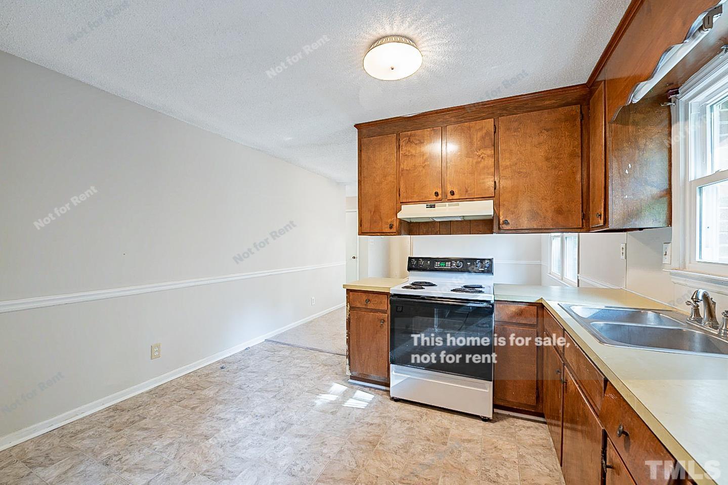4903 Fayetteville Road Durham, NC 27713 - Photo 7 of 19 a kitchen with stainless steel appliances granite countertop a stove and a sink