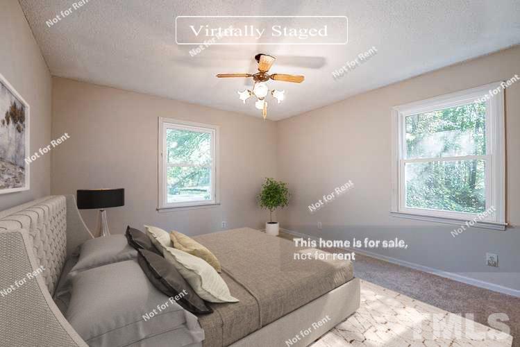 4903 Fayetteville Road Durham, NC 27713 - Photo 9 of 19 a bedroom with a large bed and a window
