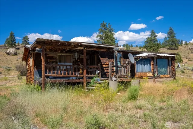 a view of a house with swimming pool and porch
