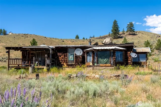 a view of a house with swimming pool and sitting area