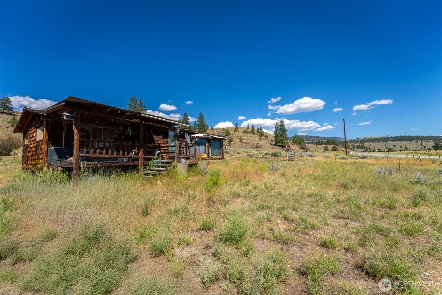 1287 State Rte 20 Tonasket, WA 98855 - Photo 4 of 9 a view of a swimming pool with outdoor seating and deck