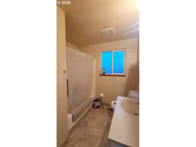 a bed room with a bed and a window