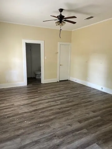 a view of an empty room and wooden floor