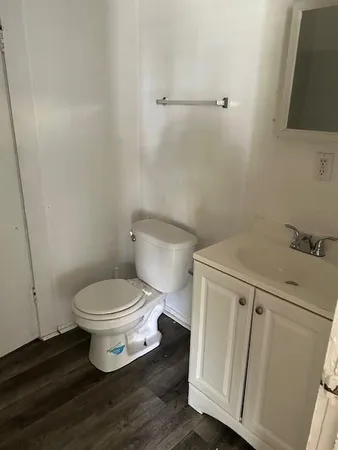 a white toilet sitting next to a bathroom sink