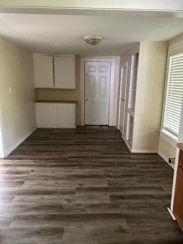 a view of a room with wooden floor