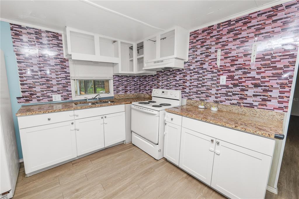 829 Nashville Road Lakeland, FL 33815 - Photo 13 of 30 a white kitchen with sink and cabinets