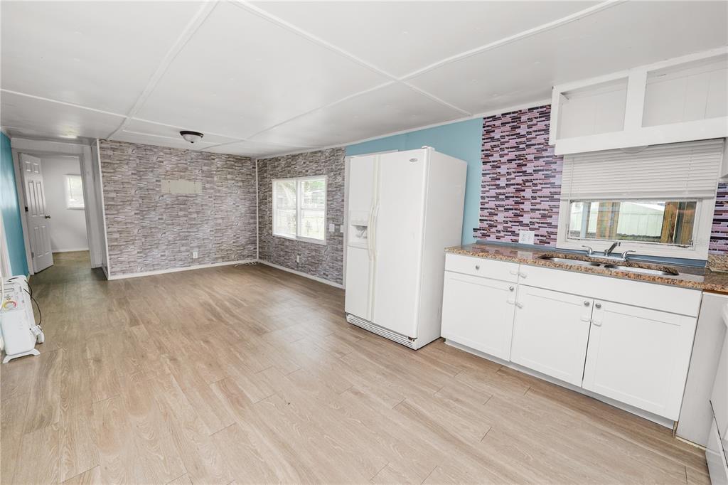 829 Nashville Road Lakeland, FL 33815 - Photo 14 of 30 a kitchen with granite countertop white cabinets and refrigerator