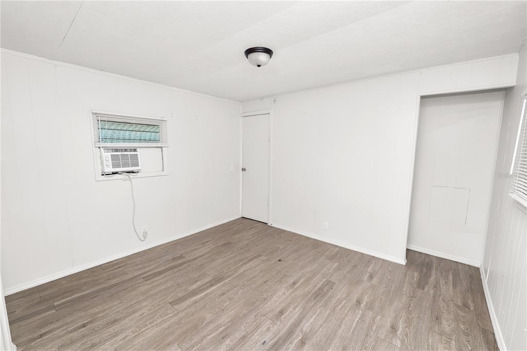 829 Nashville Road Lakeland, FL 33815 - Photo 16 of 30 an empty room with wooden floor and windows