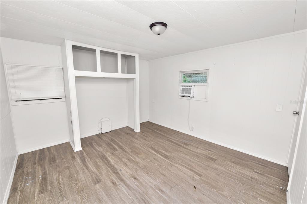 829 Nashville Road Lakeland, FL 33815 - Photo 17 of 30 a view of empty room with wooden floor and fan