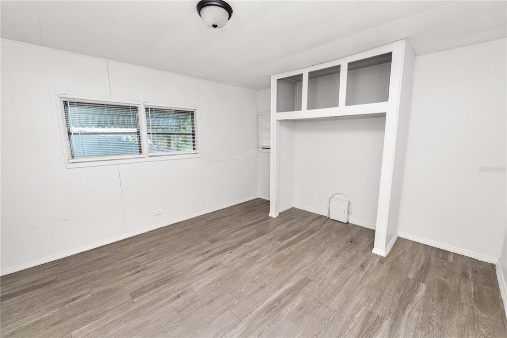 829 Nashville Road Lakeland, FL 33815 - Photo 18 of 30 an empty room with wooden floor and windows