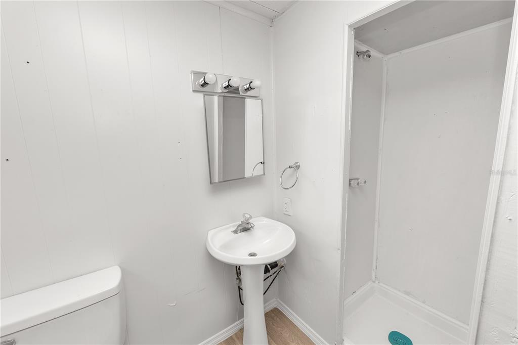 829 Nashville Road Lakeland, FL 33815 - Photo 23 of 30 a bathroom with a sink toilet and a mirror