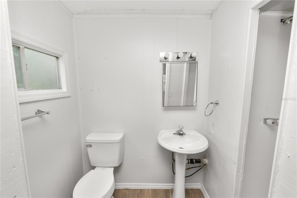829 Nashville Road Lakeland, FL 33815 - Photo 24 of 30 a bathroom with a toilet sink and mirror