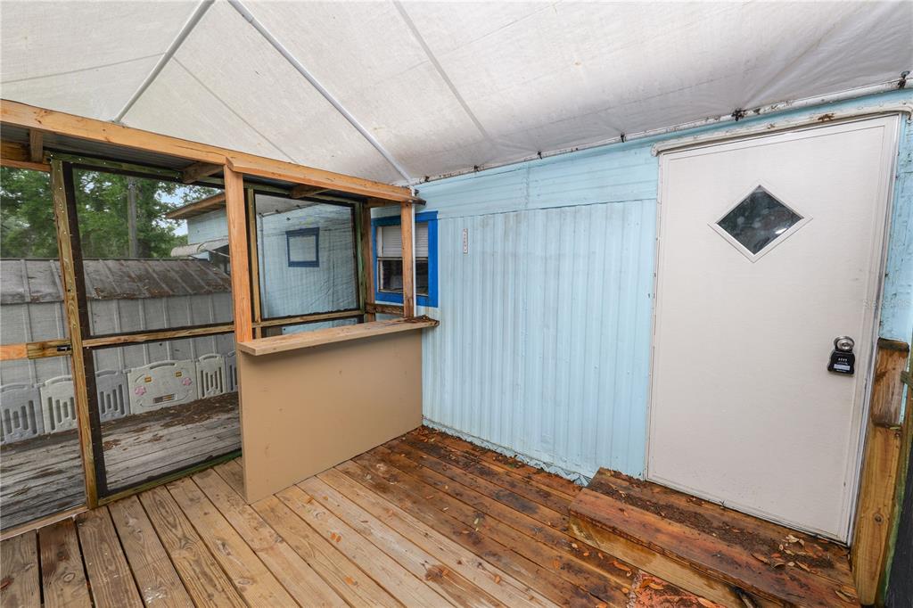 829 Nashville Road Lakeland, FL 33815 - Photo 6 of 30 a view of a hallway with wooden floor and staircase