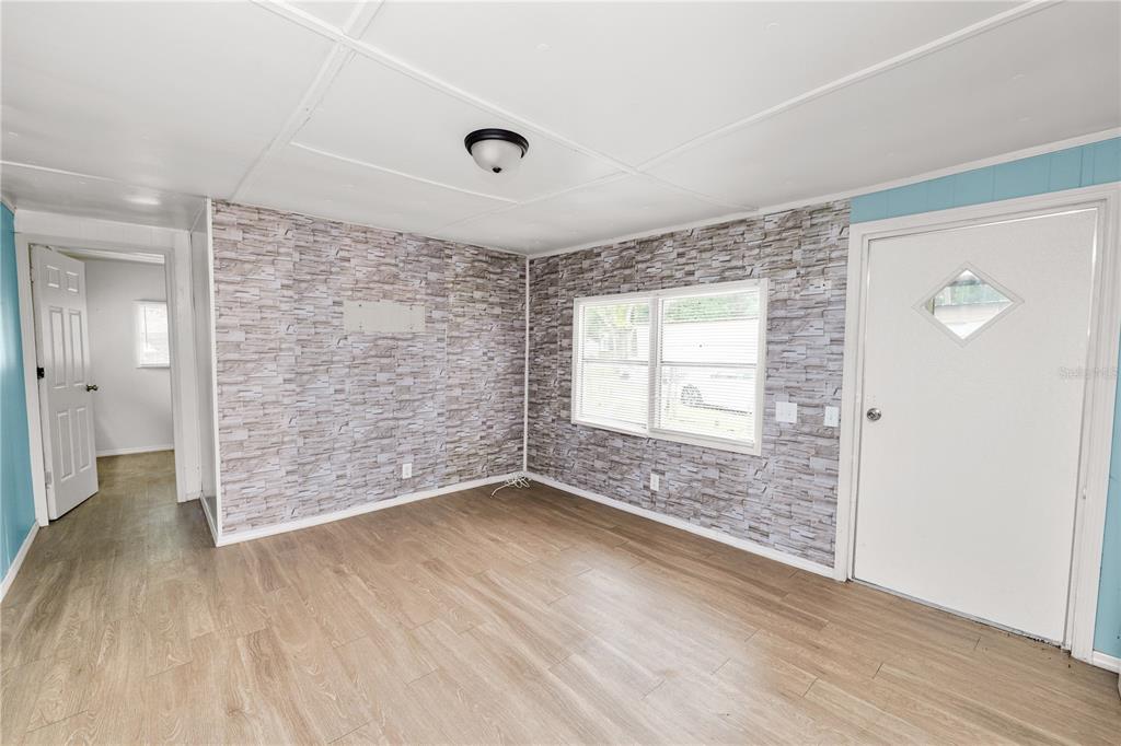 829 Nashville Road Lakeland, FL 33815 - Photo 9 of 30 an empty room with wooden floor and windows