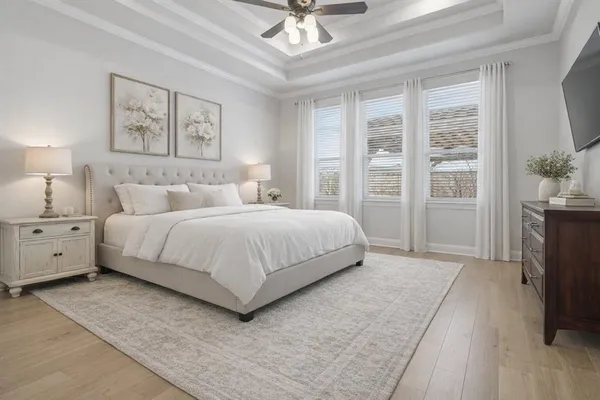 a bedroom with a large bed and a chandelier