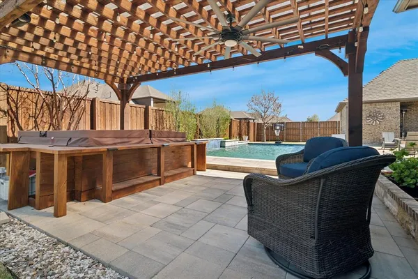 a view of a patio with table and chairs