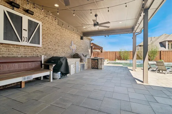 a building outdoor space with patio furniture and potted plants