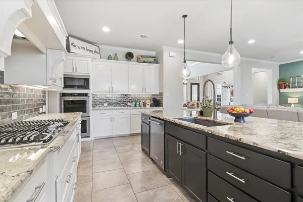 a kitchen with a sink stove and oven