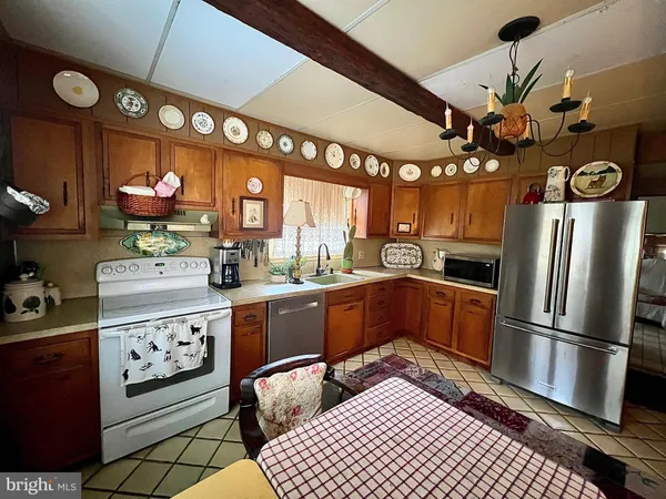 a kitchen with stainless steel appliances granite countertop a stove a refrigerator and a microwave