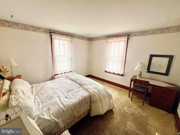 a bedroom with a bed window and a desk