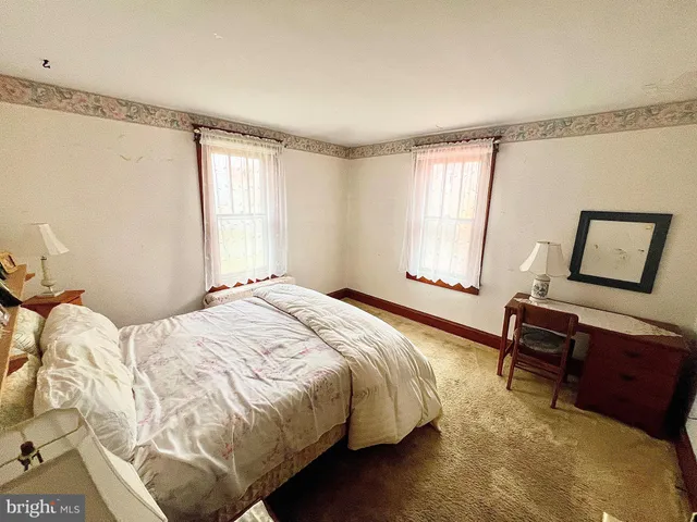 a view of swimming pool with lawn chairs and plants