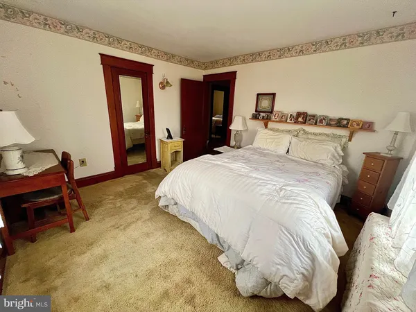 a bed sitting in a bedroom and chair