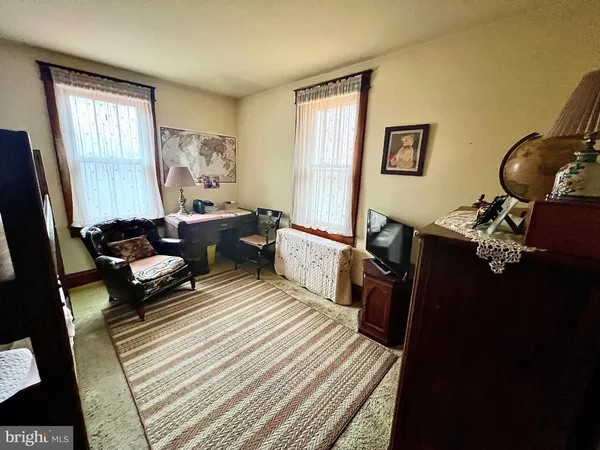 a bedroom with a bed wooden floor and a window
