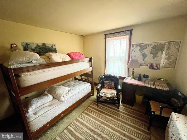 a bedroom with furniture and a window