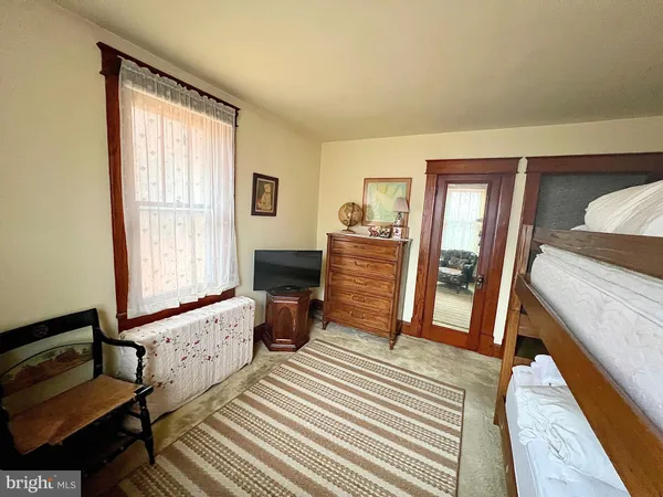 a bedroom with furniture and a window