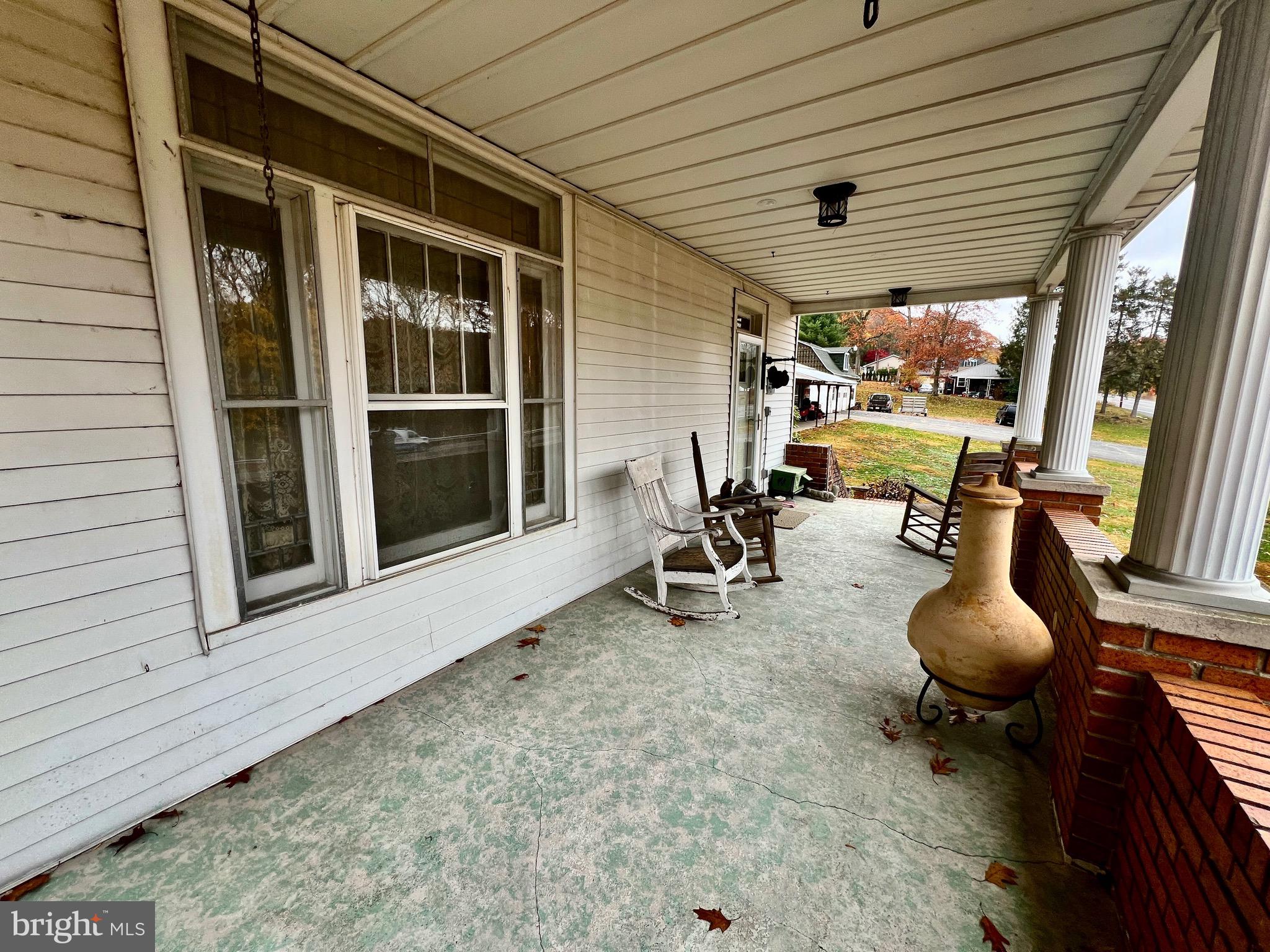 992 Fountain Street Ashland, PA 17921 - Photo 42 of 46 a view of a porch with chairs and floor to ceiling window