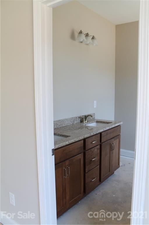 4809 Stack Road Monroe, NC 28112 - Photo 5 of 6 a bathroom with a granite countertop sink and a mirror