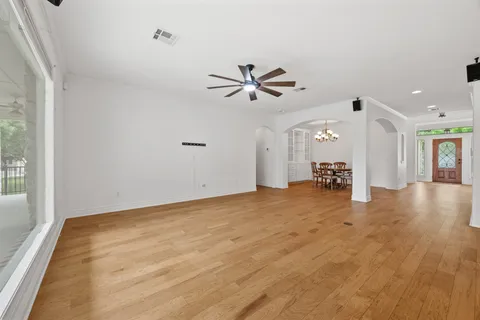 a view of a livingroom with a ceiling fan and window