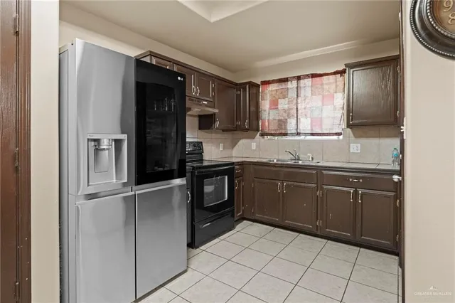 a kitchen with stainless steel appliances a stove sink and cabinets