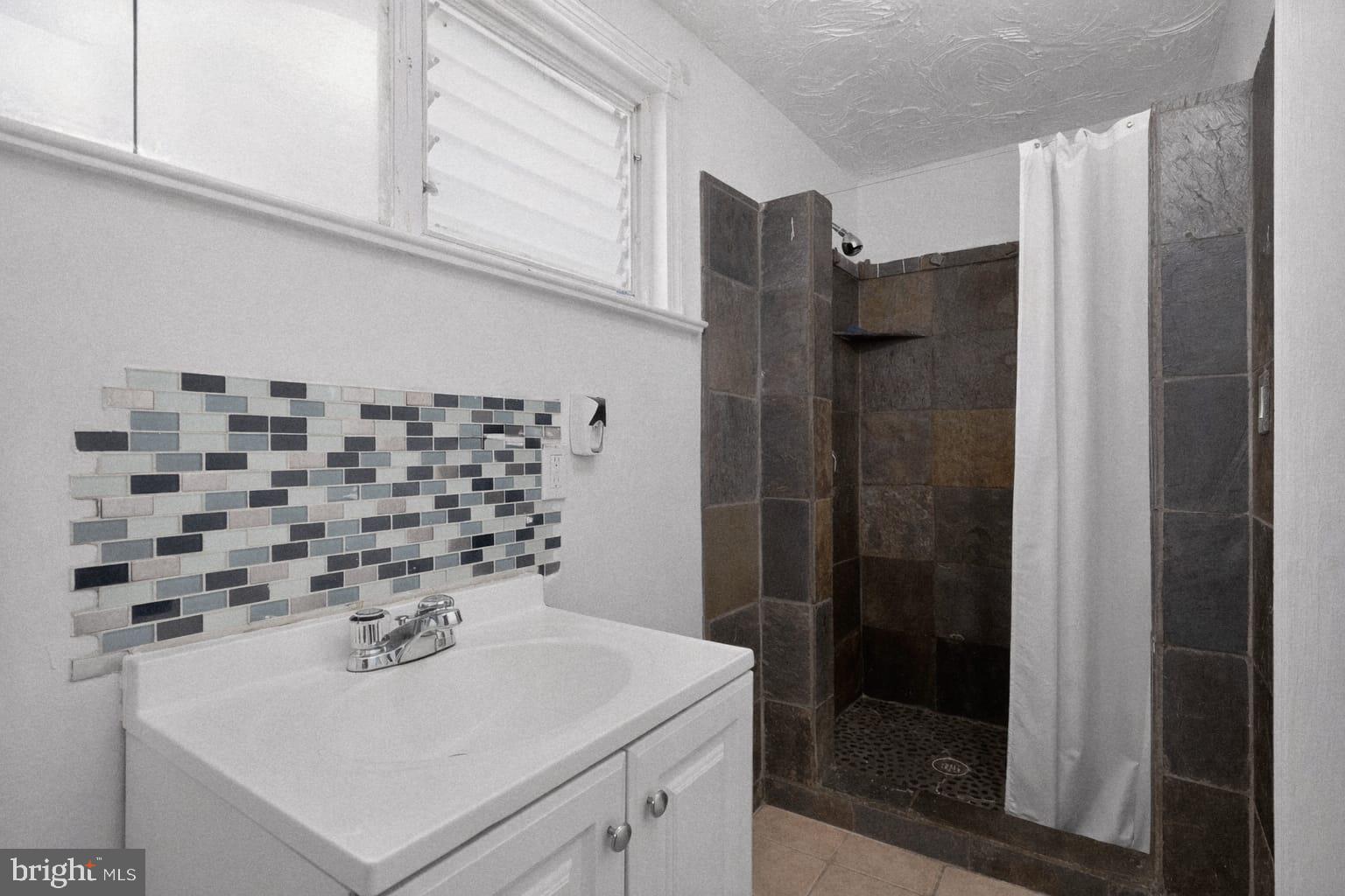 236 Kossuth Street Riverside, NJ 08075 - Photo 8 of 18 a bathroom with a sink a toilet and shower