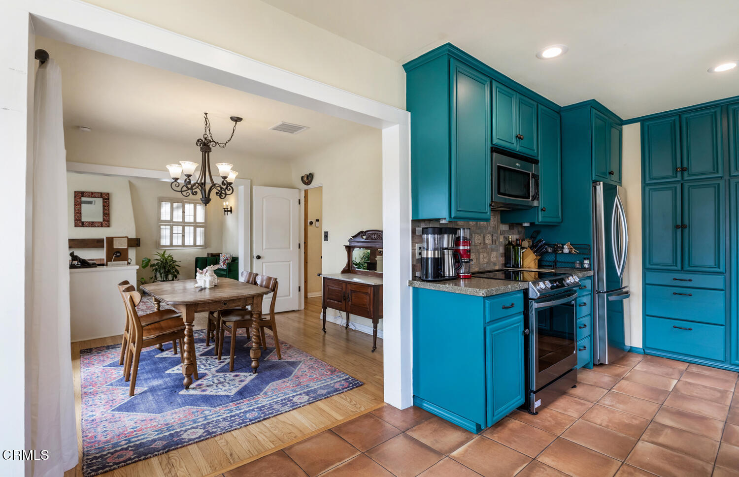 1419 Alpha Avenue Pasadena, CA 91104 - Photo 13 of 40 a kitchen with stainless steel appliances kitchen island granite countertop dining table chairs and a refrigerator