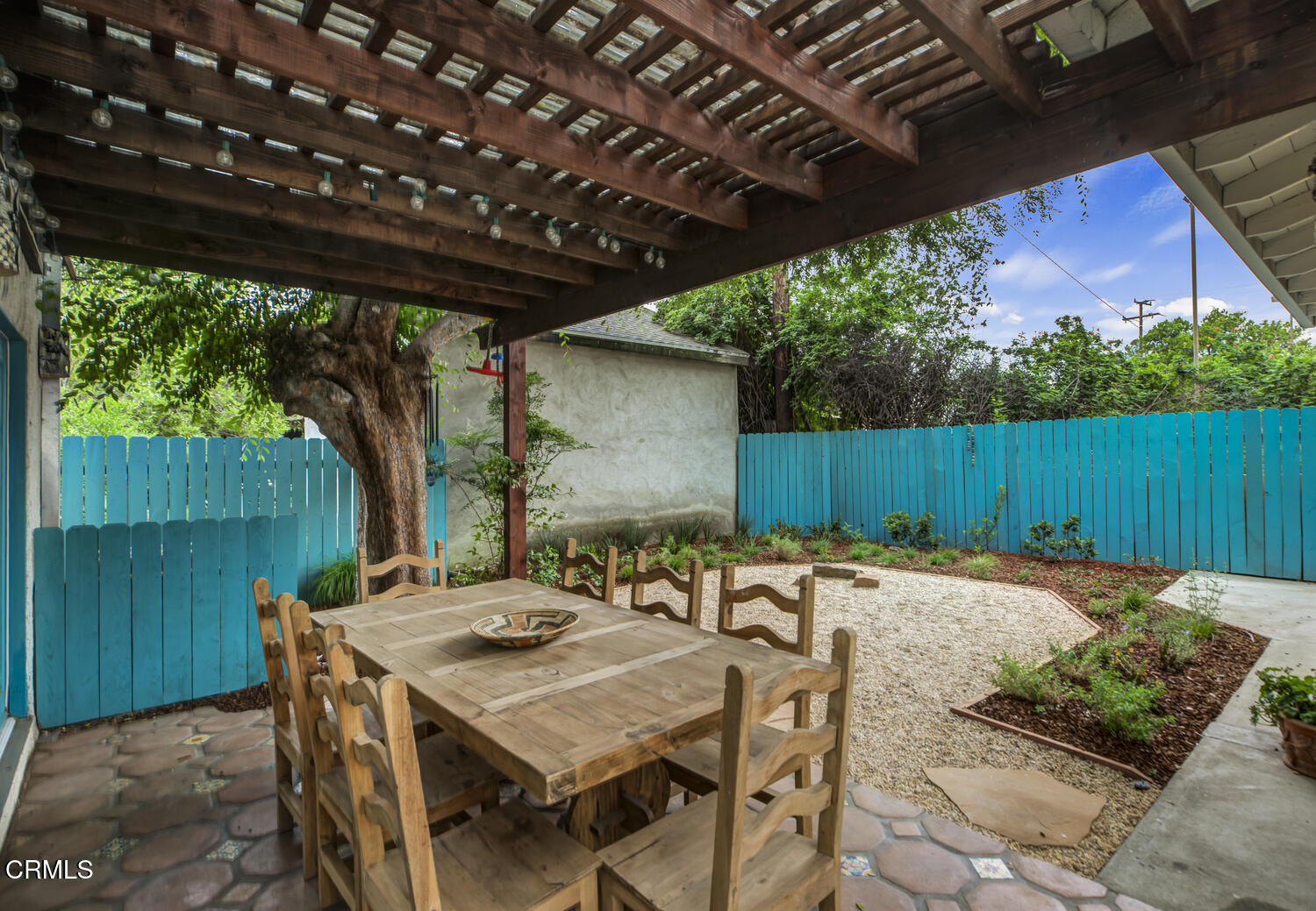 1419 Alpha Avenue Pasadena, CA 91104 - Photo 32 of 40 a backyard of a house with table and chairs with wooden fence and plants