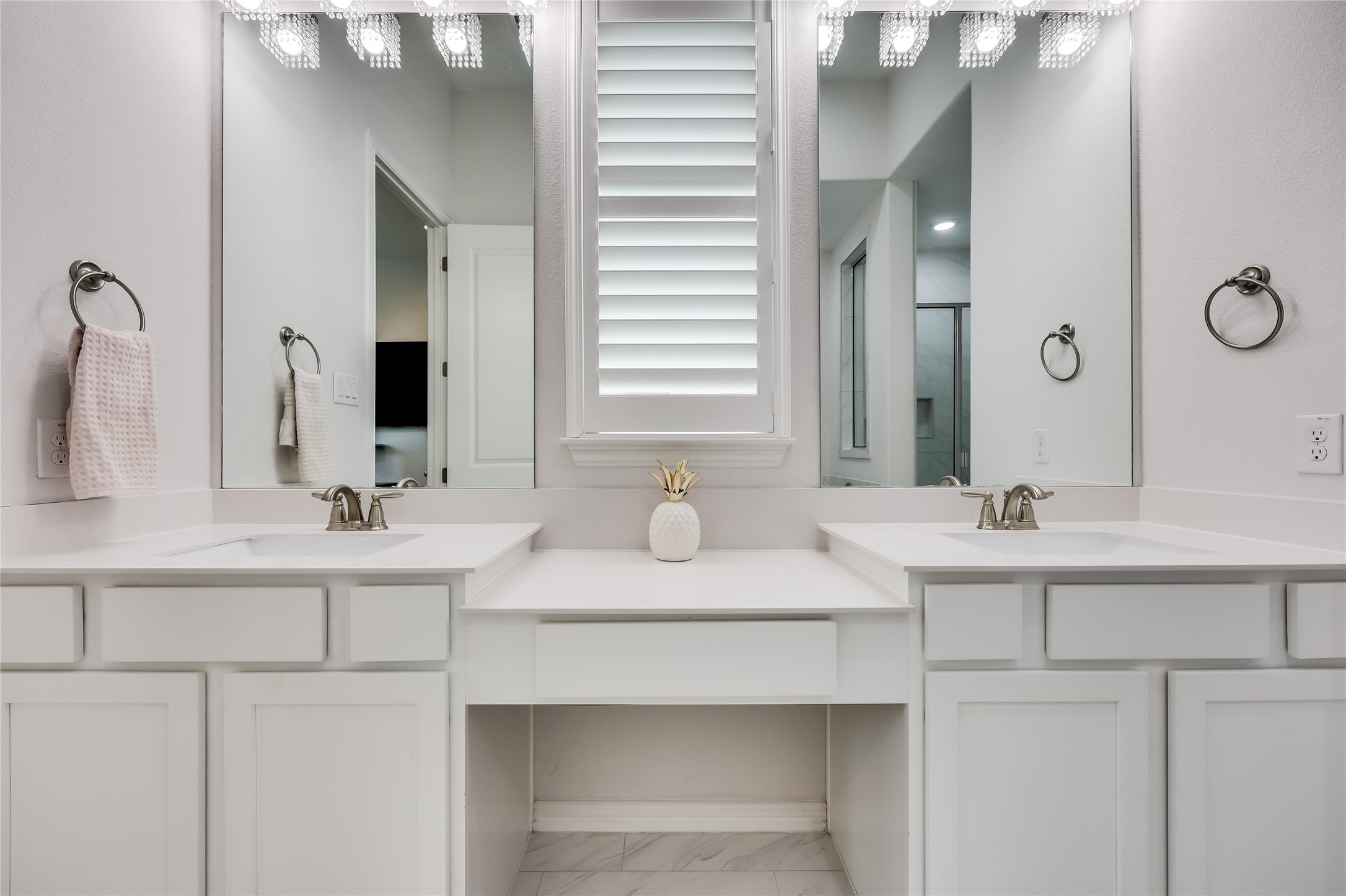 7705 Pace Ravine Drive Lago Vista, TX 78645 - Photo 17 of 40 Primary bath featuring double vanity, light marble finish flooring, and a stall shower