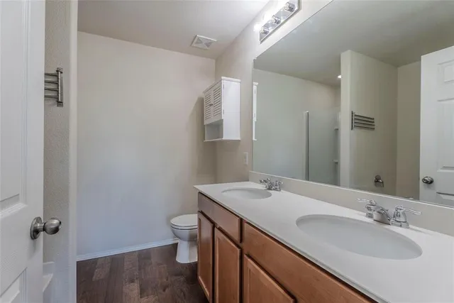 a bathroom with a sink a toilet and a mirror