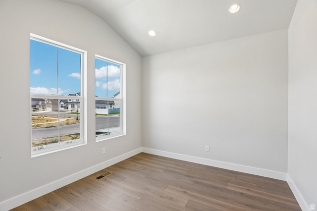 11781 South Halls Crk Road Draper, UT 84020 - Photo 5 of 33 Bright interior space featuring two large windows, wood-finish flooring, recessed lighting, and a vaulted ceiling