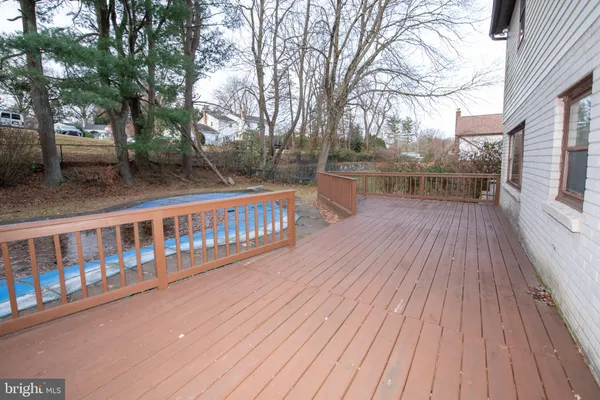 a view of a balcony with wooden floor and fence
