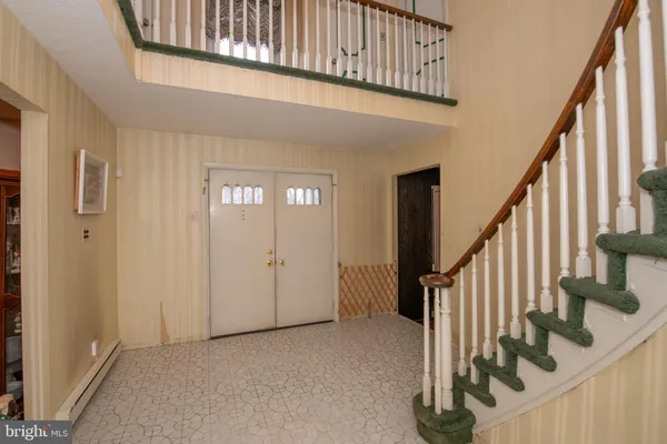 a view of an entryway with wooden floor