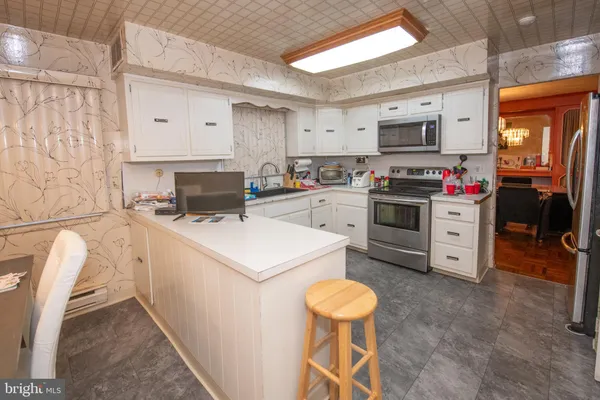 a kitchen that has a stove and a microwave