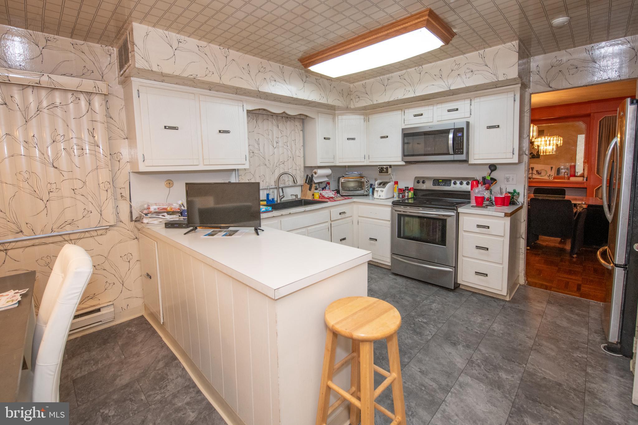 1210 Mettler Road Huntingdon Valley, PA 19006 - Photo 7 of 24 a kitchen that has a stove and a microwave