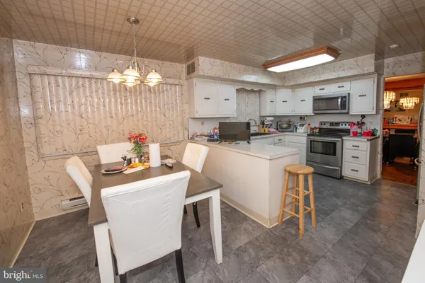 a kitchen that has a table and chairs in it