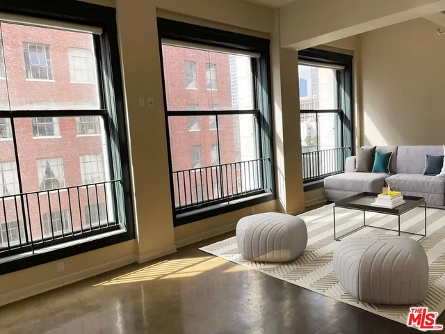 a bedroom with furniture and a large window
