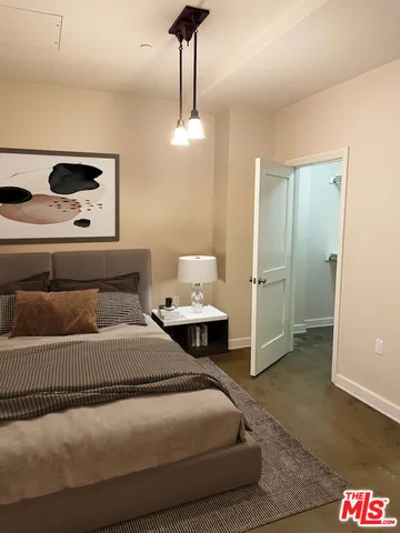 a bedroom with a bed and a table