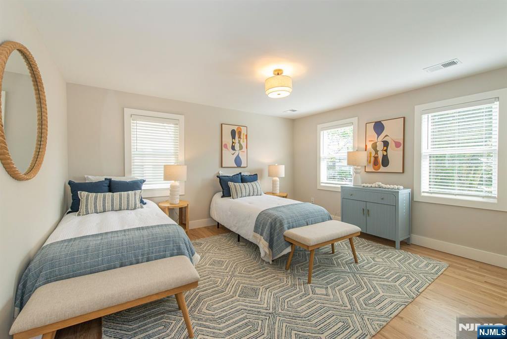 43 Alexander Avenue Montclair, NJ 07043 - Photo 30 of 50 a bedroom with a bed a mirror and a window