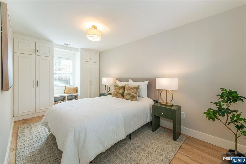 43 Alexander Avenue Montclair, NJ 07043 - Photo 35 of 50 a bedroom with bed and a potted plant