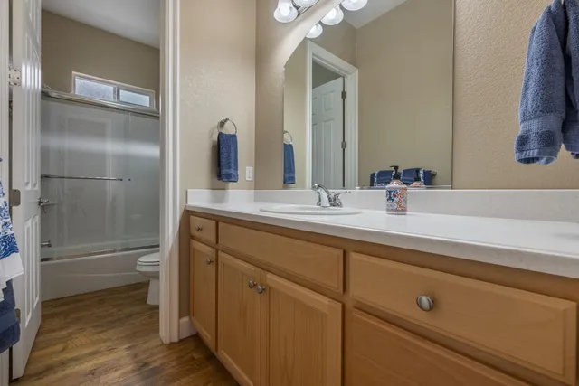 a spacious bathroom with double vanity and a mirror